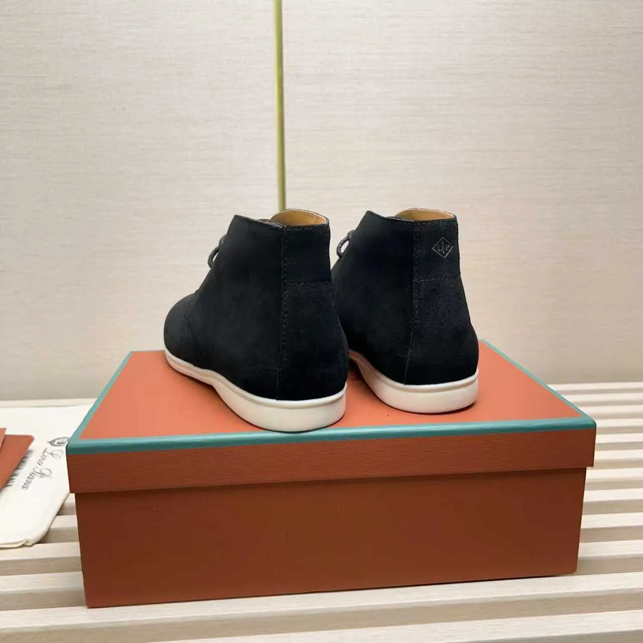 Men's Shoes 💰420 Loro Piana reimagines the desert boot—a modern, comfortable interpretation of a classic 1940s style. Crafted from suede calfskin, it exudes elegance. The tight texture of suede calfskin is not only durable but also looks casual and sophisticated. Add a timeless piece to your shoe collection, harmoniously blending comfort, style and Loro Piana's heritage of craftsmanship. Acetate satin detail on the inside White sole with LP lettering for added traction Space for a personalized signature on the heel Tonal suede trim Upper: 100% cow split suede Sole: 100% Rubber lining: Cow leather